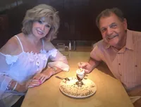 Lenora De Lemos with her husband Bob at a restaurant table